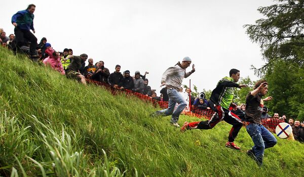 La course commence après que les organisateurs ont lancé un fromage du haut d'une colline. - Sputnik Afrique