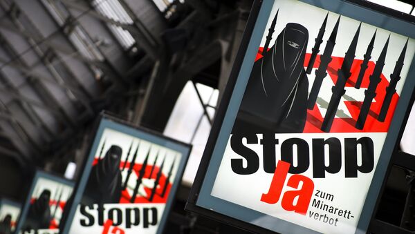 Campaign posters of the far-right Swiss People's Party depicting a woman wearing a burqa against a background of a Swiss flag upon which several minarets resembling missiles reading in German 'Stop - Yes to ban of minarets' are pictured on October 26, 2009 at the central station in Zurich. - Sputnik Afrique