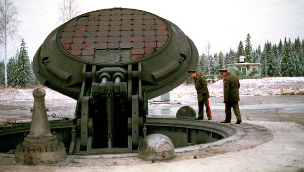 Russian high ranking military officials, look into an opened silo of a Russian intercontinental ballistic Topol-M missile somewhere at undisclosed location in Russia in this 2001 photo - Sputnik Afrique