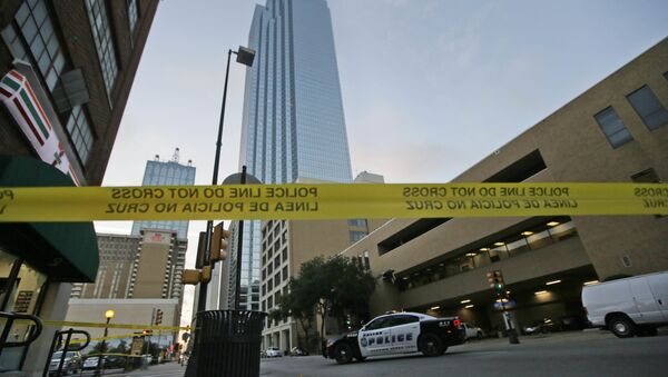 Police tape marks off the area where a shooting took place in downtown Dallas, Friday, July 8, 2016. - Sputnik Afrique