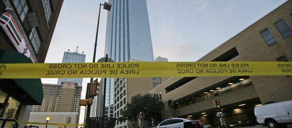 Police tape marks off the area where a shooting took place in downtown Dallas, Friday, July 8, 2016. - Sputnik Afrique