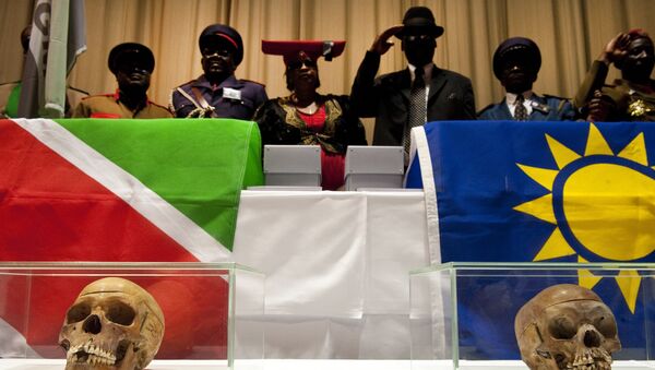 Members of a Namibian delegation stand behind two of 20 skulls following a hand-over ceremony of 20 skulls taken from Namibia, in the Charite Hospital September 30, 2011. - Sputnik Afrique