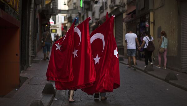 Two men carry Turkish flags for selling as they walk along a street in downtown Istanbul, Sunday, July 17, 2016. - Sputnik Afrique