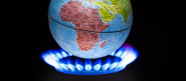 A picture taken on November 4, 2015 shows a small globe above a fire to illustrate global warming - Sputnik Afrique