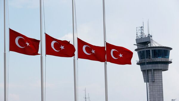 Turkish flags, with the control tower in the background, fly at half mast at the country's largest airport, Istanbul Ataturk, following yesterday's blast in Istanbul - Sputnik Afrique