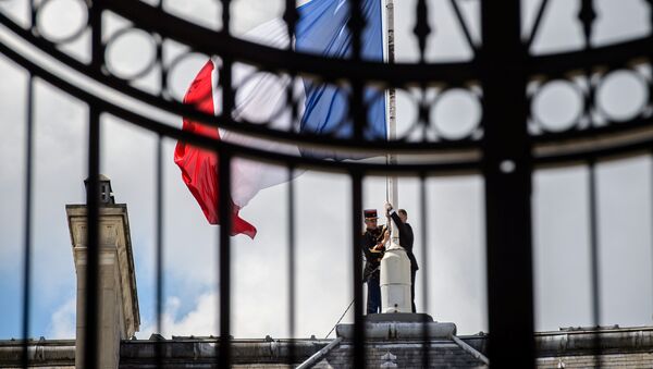 A Republican Guard lowers the French national flag at half-mast at the Elysee Palace in Paris, France, July 15, 2016, the day after the Bastille Day truck attack in Nice. - Sputnik Afrique