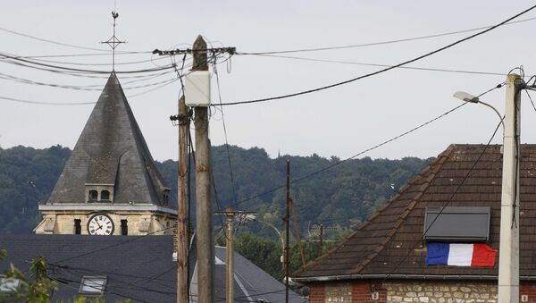 A French flag is seen on a rooftop near the bell tower of the church after a hostage-taking in Saint-Etienne-du-Rouvray near Rouen in Normandy, France, July 26, 2016. - Sputnik Afrique