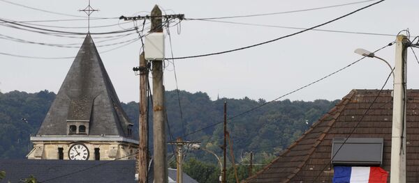 A French flag is seen on a rooftop near the bell tower of the church after a hostage-taking in Saint-Etienne-du-Rouvray near Rouen in Normandy, France, July 26, 2016. - Sputnik Afrique