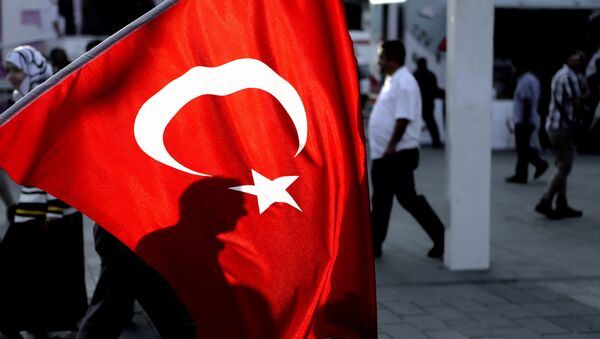 A man's shadow is seen behind a Turkish flag at Taksim square in Istanbul, on Saturday, July 30, 2016. - Sputnik Afrique