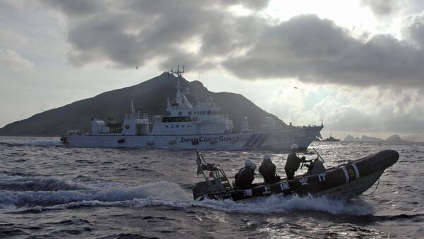 In this Sunday, Aug. 18, 2013 file photo, Japanese Coast Guard boat and vessel sail alongside Japanese activists' fishing boat, not in photo, warning the activists away from a group of disputed islands called Diaoyu by China and Senkaku by Japan - Sputnik Afrique