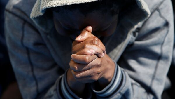 A migrant prays on the Migrant Offshore Aid Station (MOAS) ship Topaz Responder after being rescued around 20 nautical miles off the coast of Libya, June 23, 2016. - Sputnik Afrique