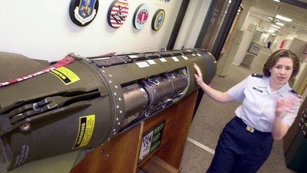 Second Lt. Tracie Martin, the project manager of the Air Armament Center Area Attack Systems Program Office at Eglin Air Force Base near Pensacola, Fla. shows the Sensor Fuzed Weapon missile, Thursday February 13, 2003. - Sputnik Afrique
