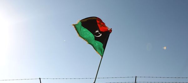 A man waves a Libyan flag as fighter jet flies by at the Zueitina oil terminal on September 14, 2016. - Sputnik Afrique