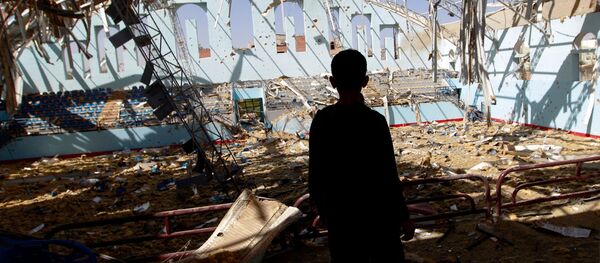 A Yemeni boy inspect the damage at a sports hall that was partially destroyed by Saudi-led air strikes in the Yemeni capital Sanaa on January 19, 2016. - Sputnik Afrique