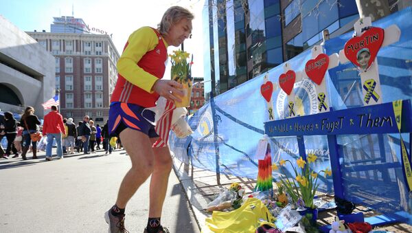 A runner pays his respects at a makeshift memorial honoring to the victims of the 2013 Boston Marathon bombings. - Sputnik Afrique