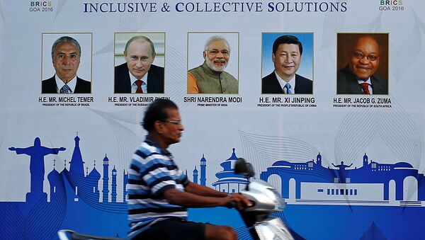 A man rides past a billboard near one of the venues of BRICS (Brazil, Russia, India, China and South Africa) Summit in Benaulim, in the western state of Goa, India October 14, 2016. - Sputnik Afrique