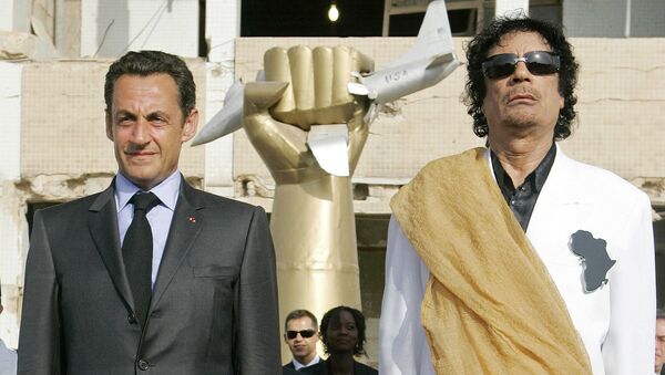 This July 25, 2007 file photo shows Libyan leader Moammar Gadhafi, right, and French President Nicolas Sarkozy standing while national anthems are being played, at the Bab Azizia Palace in Tripoli, Libya - Sputnik Afrique
