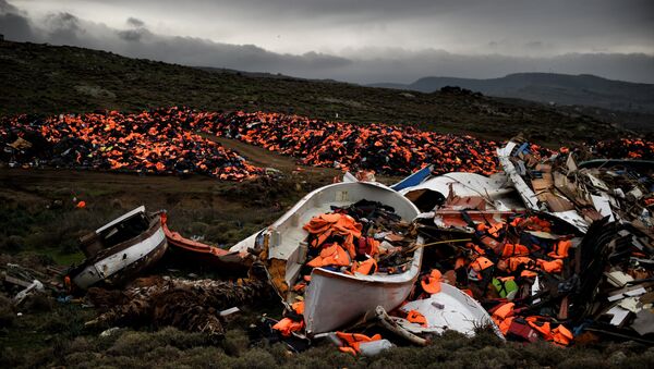 Wrecked boats and thousands of life jackets used by refugees and migrants during their journey across the Aegean sea lie in a dump in Mithimna on February 19, 2016. - Sputnik Afrique