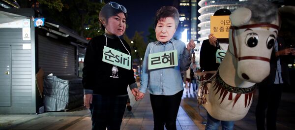 Protesters wearing cut-out of South Korean President Park Geun-hye (C) and Choi Soon-sil attend a protest denouncing President Park Geun-hye over a recent influence-peddling scandal in central Seoul, South Korea, October 27, 2016. - Sputnik Afrique