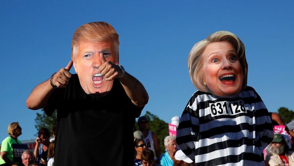 Craig Wendel dresses as Trump and his wife wears a Clinton mask as they support Trump at a campaign rally in Naples, Florida - Sputnik Afrique
