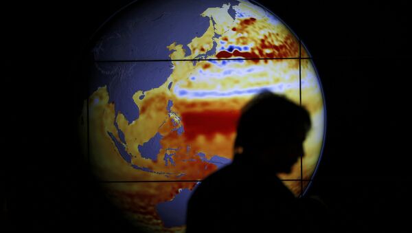 A woman walks past a map showing the elevation of the sea in the last 22 years during the World Climate Change Conference 2015 (COP21) at Le Bourget, near Paris, France, December 11, 2015 - Sputnik Afrique