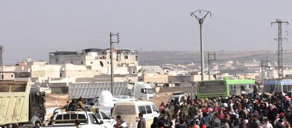 Syrians that evacuated the eastern districts of Aleppo gather to board buses, in a government held area in Aleppo, Syria in this handout picture provided by SANA on November 29, 2016. - Sputnik Afrique