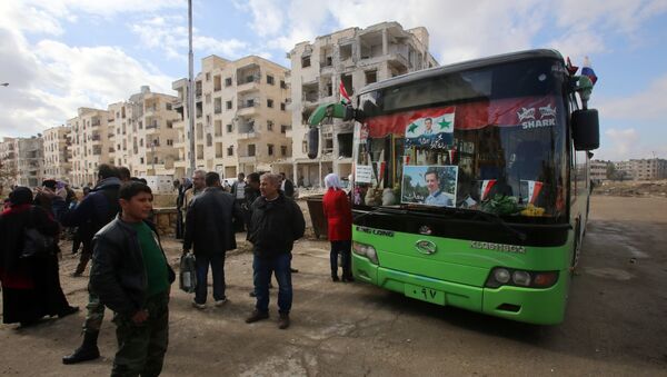 Syrians, from various western districts, wait at the Razi bus stop in Aleppo's central Jamiliyeh neighbourhood before taking part in a bus trip through government-held territory between the two sides of the divided city on December 3, 2016 as the pro-government forces seized 60 percent of the former rebel stronghold in east Aleppo - Sputnik Afrique