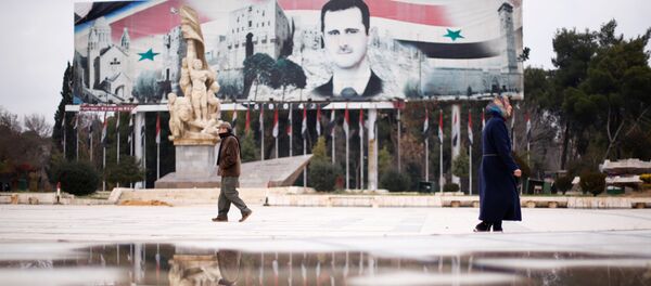 People walk past a billboard depicting Syria's President Bashar al-Assad at Saadallah al-Jabri Square, in the government controlled area of Aleppo, Syria - Sputnik Afrique