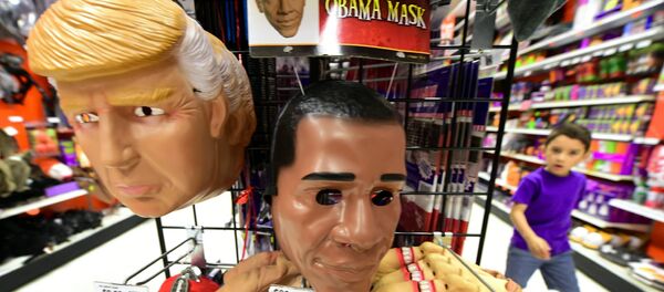A child walks past a display of masks of US President Barack Obama, and presidential hopefuls Donald Trump and Hillary Clinton, for sale at a shop selling Halloween items in Alhambra, California on October 21, 2016 - Sputnik Afrique