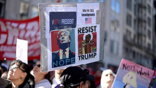 Protesters hold up signs during a march and rally against the United States President-elect Donald Trump in Los Angeles, California, U.S. December 18, 2016. - Sputnik Afrique