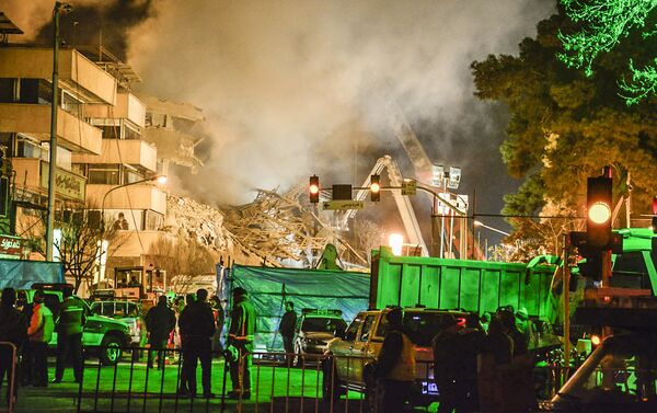 Les pompiers déblaient les décombres sur les lieux de l'effondrement d'un immeuble à Téhéran - Sputnik Afrique