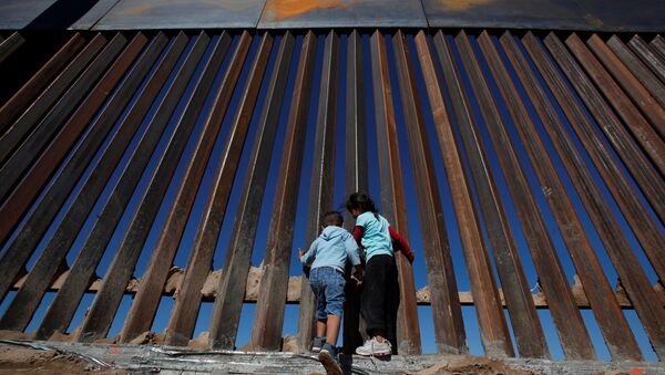 Children play at a newly built section of the U.S.-Mexico border wall at Sunland Park, U.S. opposite the Mexican border city of Ciudad Juarez, Mexico November 18, 2016 - Sputnik Afrique