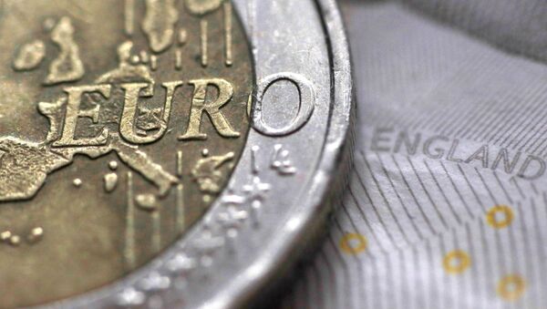 A two Euro coin is pictured next to an English ten Pound note in an illustration - Sputnik Afrique