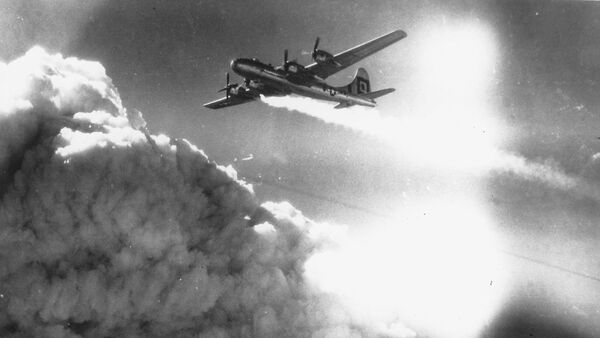 In flight over the Japanese city of Kobe, a U.S. Army Air Forces B-29 Superfortress trails smoke and fire, on July 17, 1945. - Sputnik Afrique