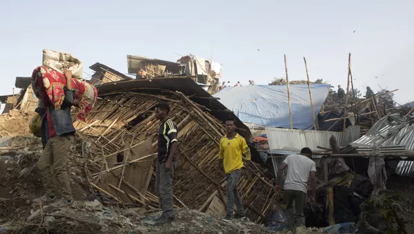 People move their belongings on March 12, 2017 after dwellings built near the main landfill of Addis Ababa on the outskirts of the city were damaged in a landslide that left at least 30 people dead.