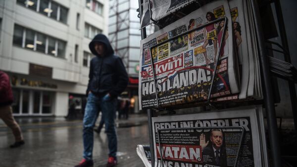 Une personne passe devant un kiosque de journaux montrant ses premières pages portant les titres concernant les tensions diplomatiques entre la Turquie et les Pays-Bas, exposées à Istanbul le 13 mars 2017 - Sputnik Afrique