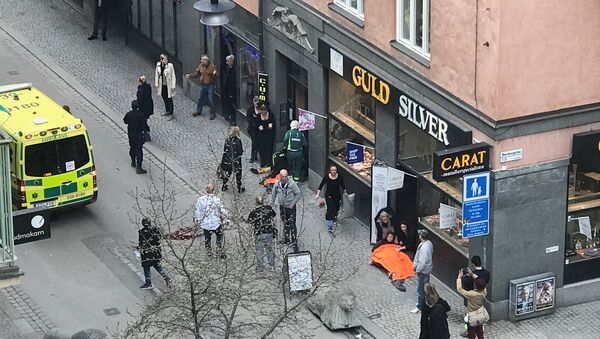 Ambulance in a street near the site were a truck was driven into a crowd in central Stockholm, Sweden - Sputnik Afrique