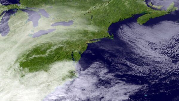 This satellite image taken around 3:11 p.m. EDT and released by the National Oceanic and Atmospheric Administration, shows clouds around the Northeast of the United States, Monday, March 13, 2017. - Sputnik Afrique