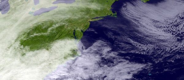 This satellite image taken around 3:11 p.m. EDT and released by the National Oceanic and Atmospheric Administration, shows clouds around the Northeast of the United States, Monday, March 13, 2017. - Sputnik Afrique