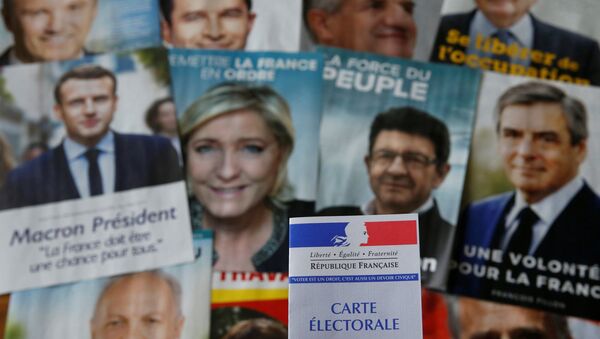 A photo illustration shows a French voter card in front of pictures of the candidates for the French presidential election - Sputnik Afrique