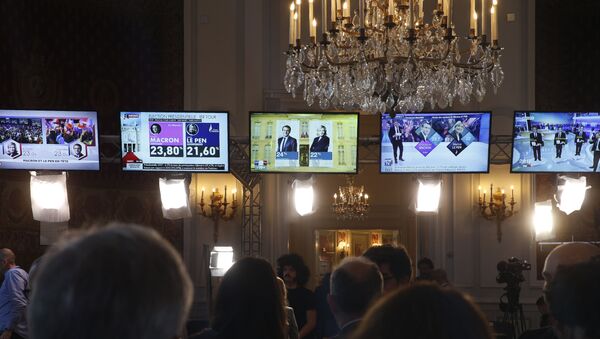 People look at TV screens displaying the results of the first round of the presidential election, on April 23, 2017, at the interior ministry in Paris. - Sputnik Afrique