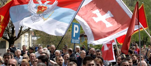Demonstrators wave flags during anti-NATO protest as Montenegro’s parliament discusses NATO membership agreement in Cetinje, Montenegro, April 28, 2017 - Sputnik Afrique