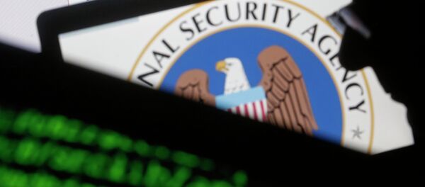 A man is seen near cyber code and the U.S. National Security Agency logo in this photo illustration taken in Sarajevo March 11, 2015 - Sputnik Afrique
