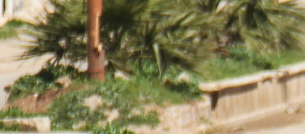 A Syrian man collects samples from the site of a suspected toxic gas attack in Khan Sheikhun, in Syria’s northwestern Idlib province, on April 5, 2017. - Sputnik Afrique