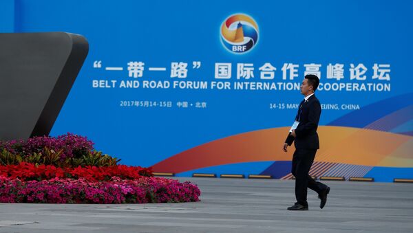 A man walks past the China National Convention Center, a venue of the upcoming Belt and Road Forum in Beijing, China, May 12, 2017. - Sputnik Afrique