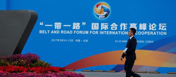 A man walks past the China National Convention Center, a venue of the upcoming Belt and Road Forum in Beijing, China, May 12, 2017. A man walks past the China National Convention Center, a venue of the upcoming Belt and Road Forum in Beijing, China, May 12, 2017. - Sputnik Afrique