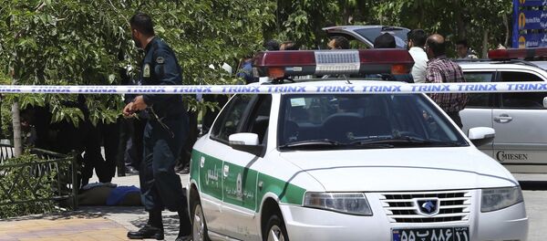 The body of a terrorist, at background left, lies on the ground while police control the scene at the shine of late Iranian revolutionary founder Ayatollah Khomeini, just outside Tehran, Iran, Wednesday, June 7, 2017. - Sputnik Afrique