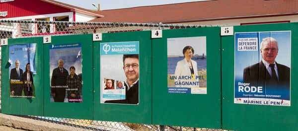 Campaign posters for the French legislative elections are displayed outside a polling station in the French overseas territory of Saint-Pierre - Sputnik Afrique