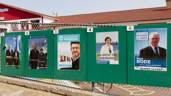 Campaign posters for the French legislative elections are displayed outside a polling station in the French overseas territory of Saint-Pierre - Sputnik Afrique