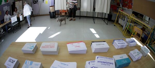 A person leaves a polling booth during the first round of French parliamentary election in Nice - Sputnik Afrique